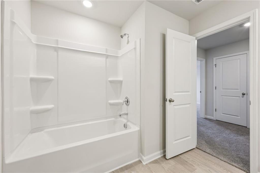 471 Tallulah Lane Grayson, GA 30017 - Photo 32 of 38 a bathroom with a bathtub and a shower
