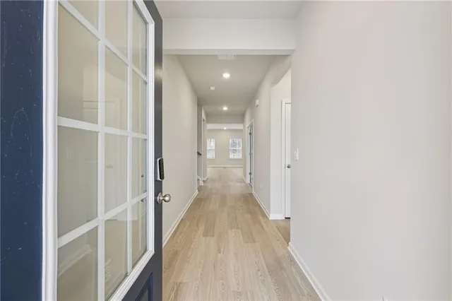 an empty room with windows and fireplace