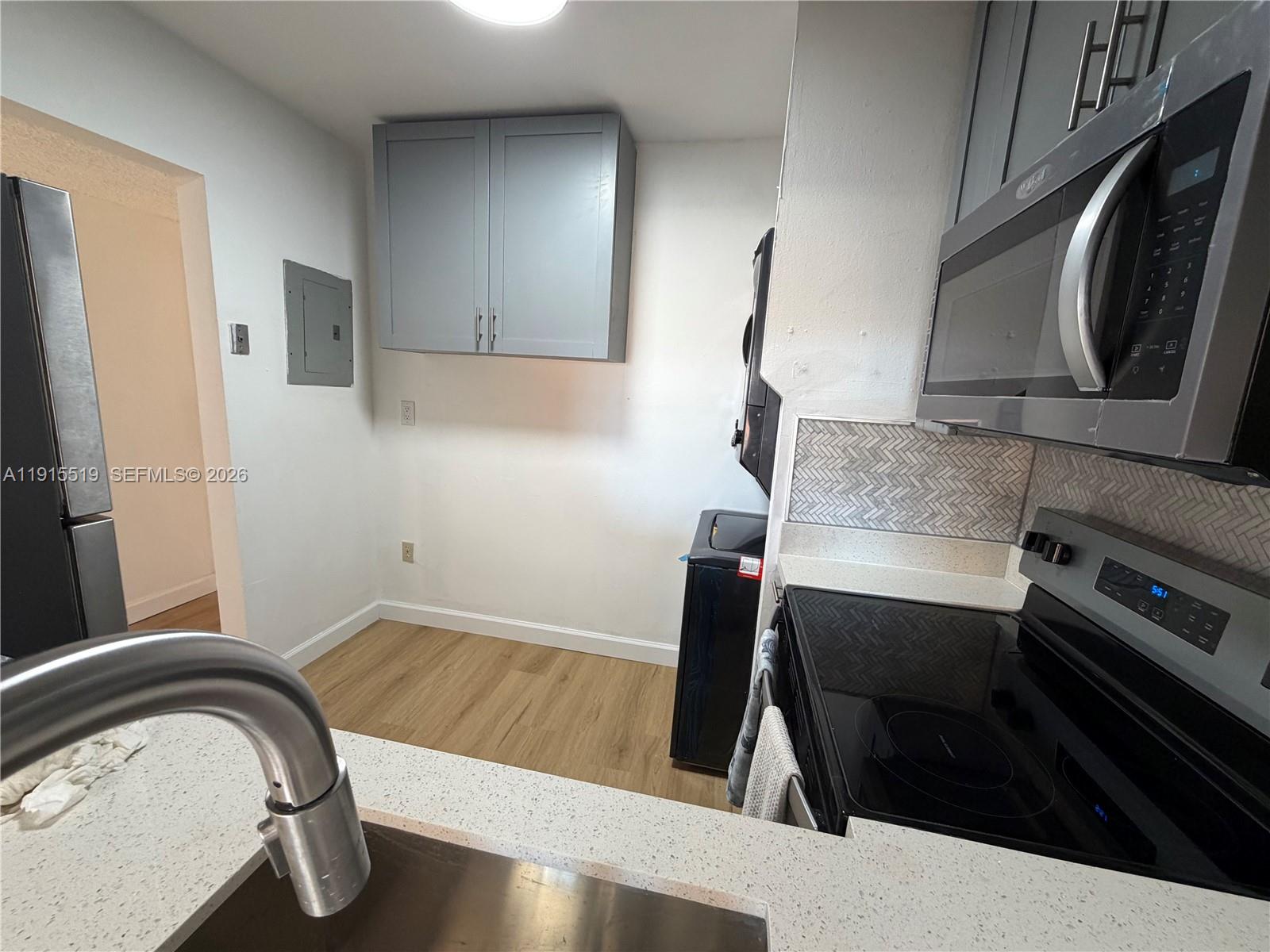 440 East 23rd Street, Unit 1305 Hialeah, FL 33013 - Photo 14 of 15 a bathroom with a sink a mirror and bathtub