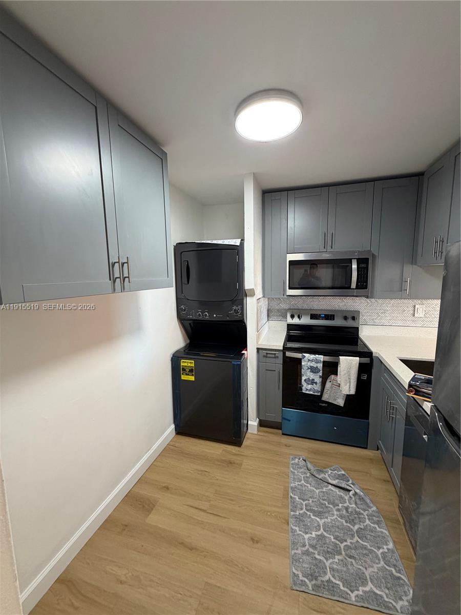 440 East 23rd Street, Unit 1305 Hialeah, FL 33013 - Photo 15 of 15 a kitchen with a refrigerator and a stove top oven