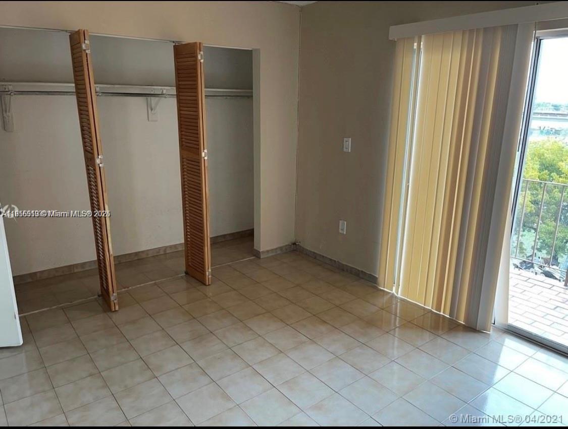440 East 23rd Street, Unit 1305 Hialeah, FL 33013 - Photo 3 of 12 an empty room with windows