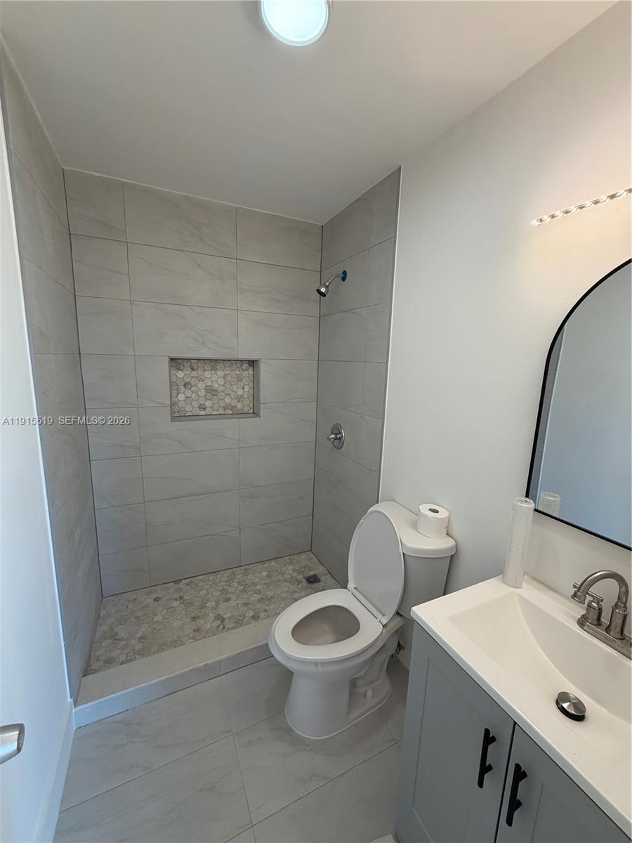 440 East 23rd Street, Unit 1305 Hialeah, FL 33013 - Photo 6 of 15 a bathroom with a sink a toilet and shower