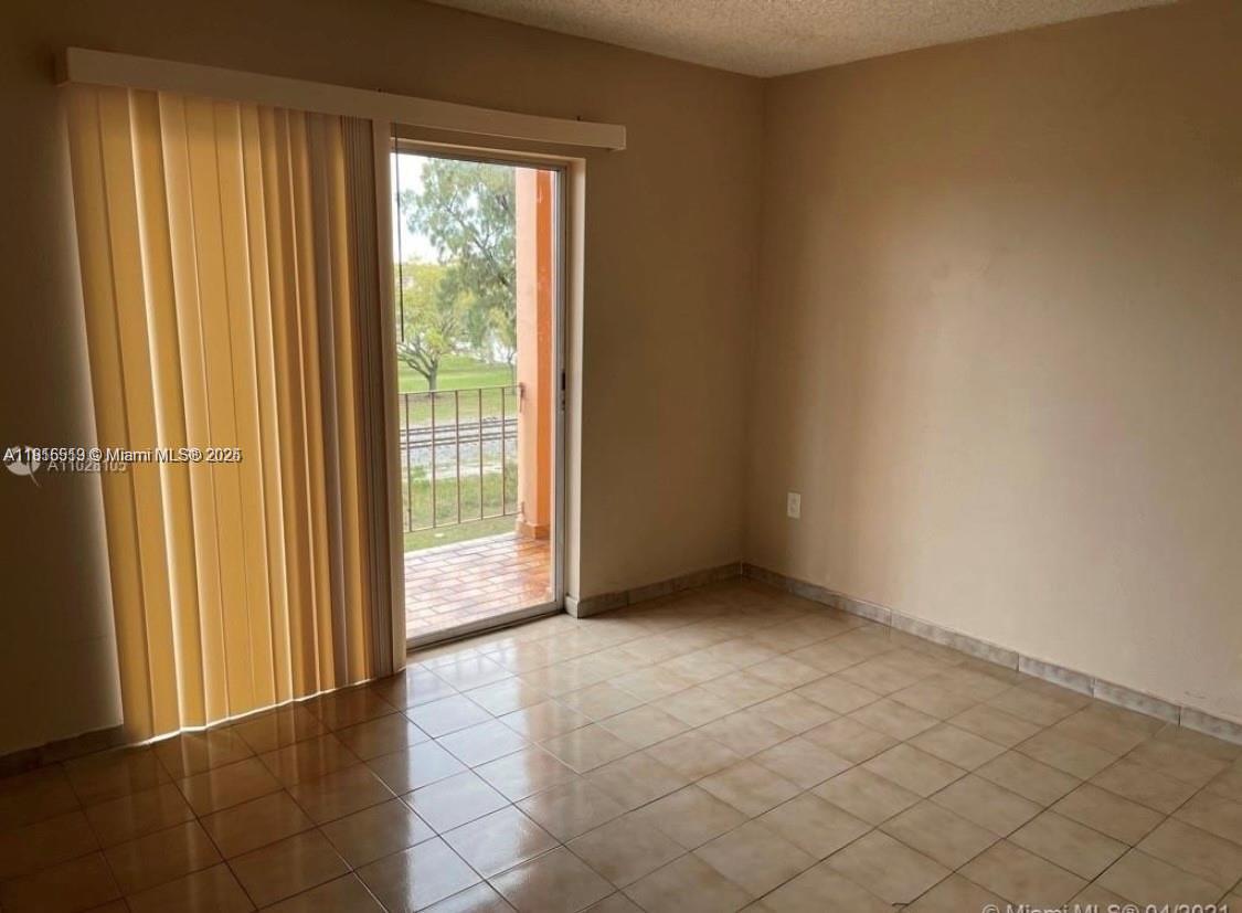 440 East 23rd Street, Unit 1305 Hialeah, FL 33013 - Photo 8 of 12 an empty room with windows