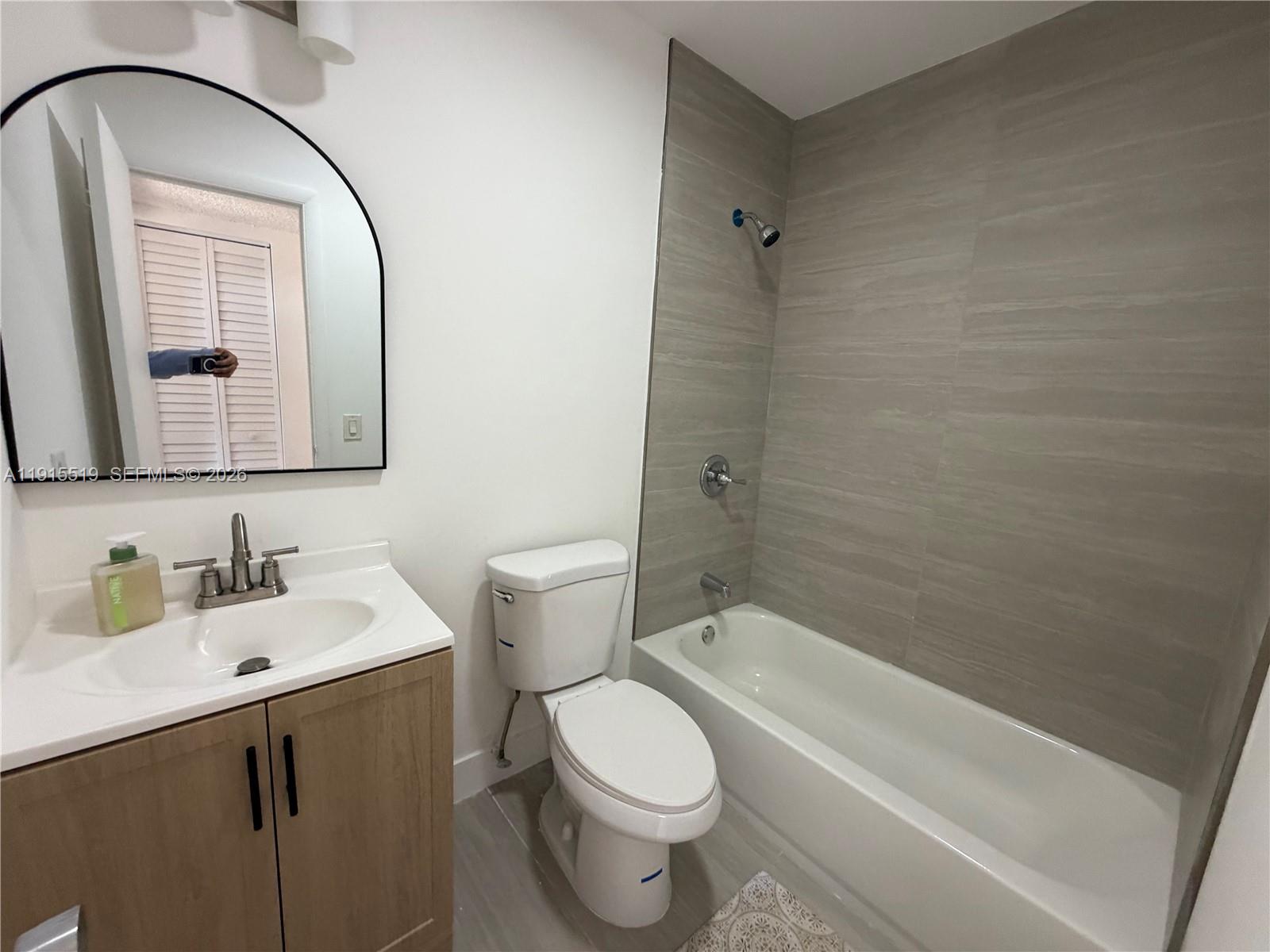 440 East 23rd Street, Unit 1305 Hialeah, FL 33013 - Photo 8 of 15 a bathroom with a toilet sink and mirror