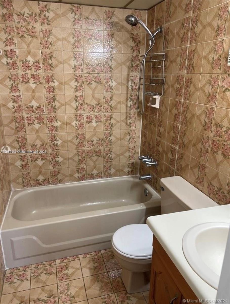 440 East 23rd Street, Unit 1305 Hialeah, FL 33013 - Photo 9 of 12 a bathroom with a sink a toilet and bathtub