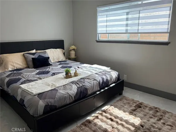 a bedroom with a bed and window