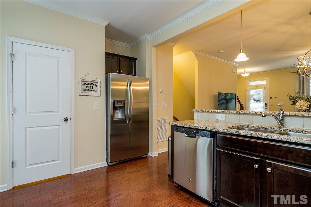 1547 Crafton Way Raleigh, NC 27607 - Photo 14 of 27 a kitchen with stainless steel appliances granite countertop a sink and a refrigerator