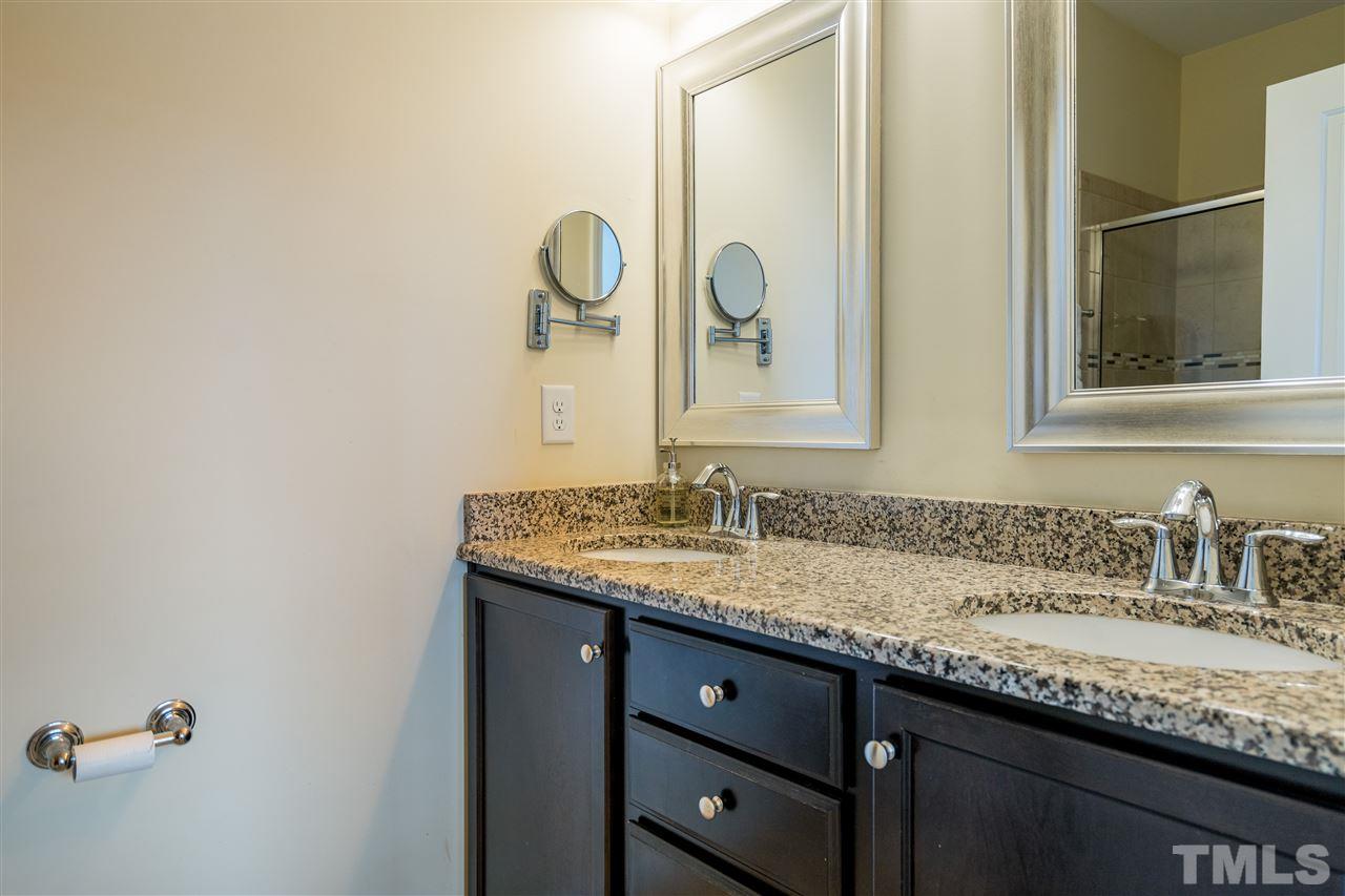 1547 Crafton Way Raleigh, NC 27607 - Photo 19 of 27 a bathroom with a granite countertop sink and a mirror