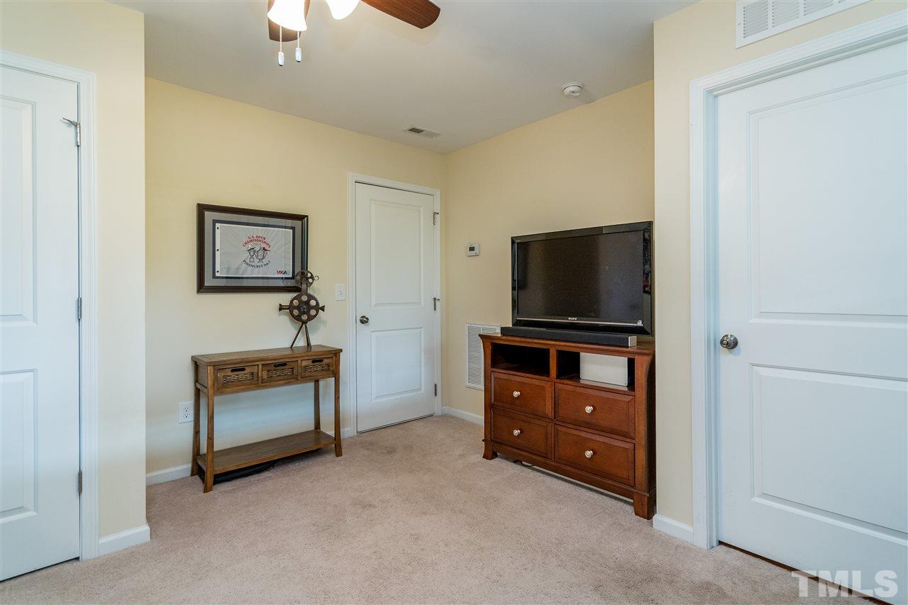 1547 Crafton Way Raleigh, NC 27607 - Photo 24 of 27 a living room with furniture and a flat screen tv