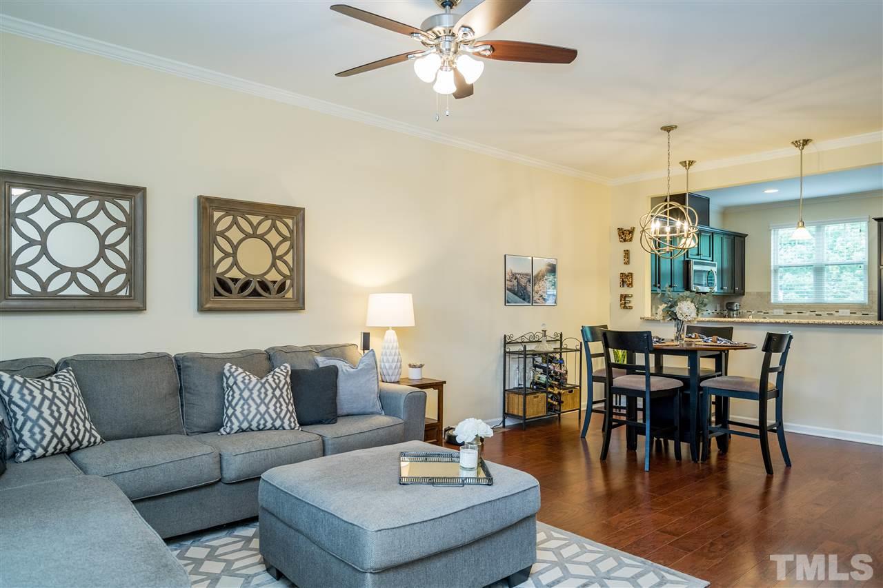 1547 Crafton Way Raleigh, NC 27607 - Photo 8 of 27 a living room with couches chairs and a dining table with wooden floor