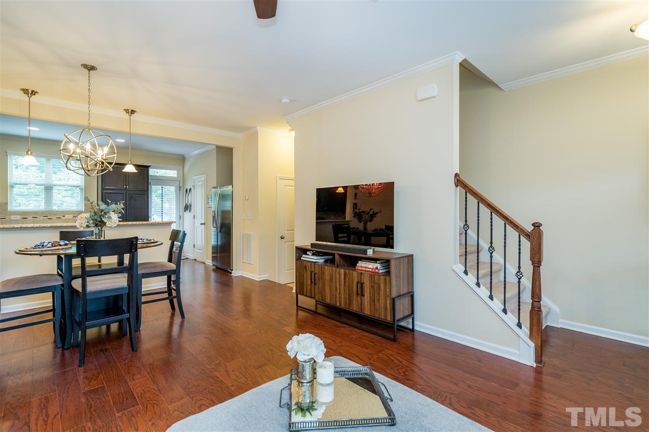 1547 Crafton Way Raleigh, NC 27607 - Photo 9 of 27 a view of a livingroom with furniture a flat screen tv and wooden floor