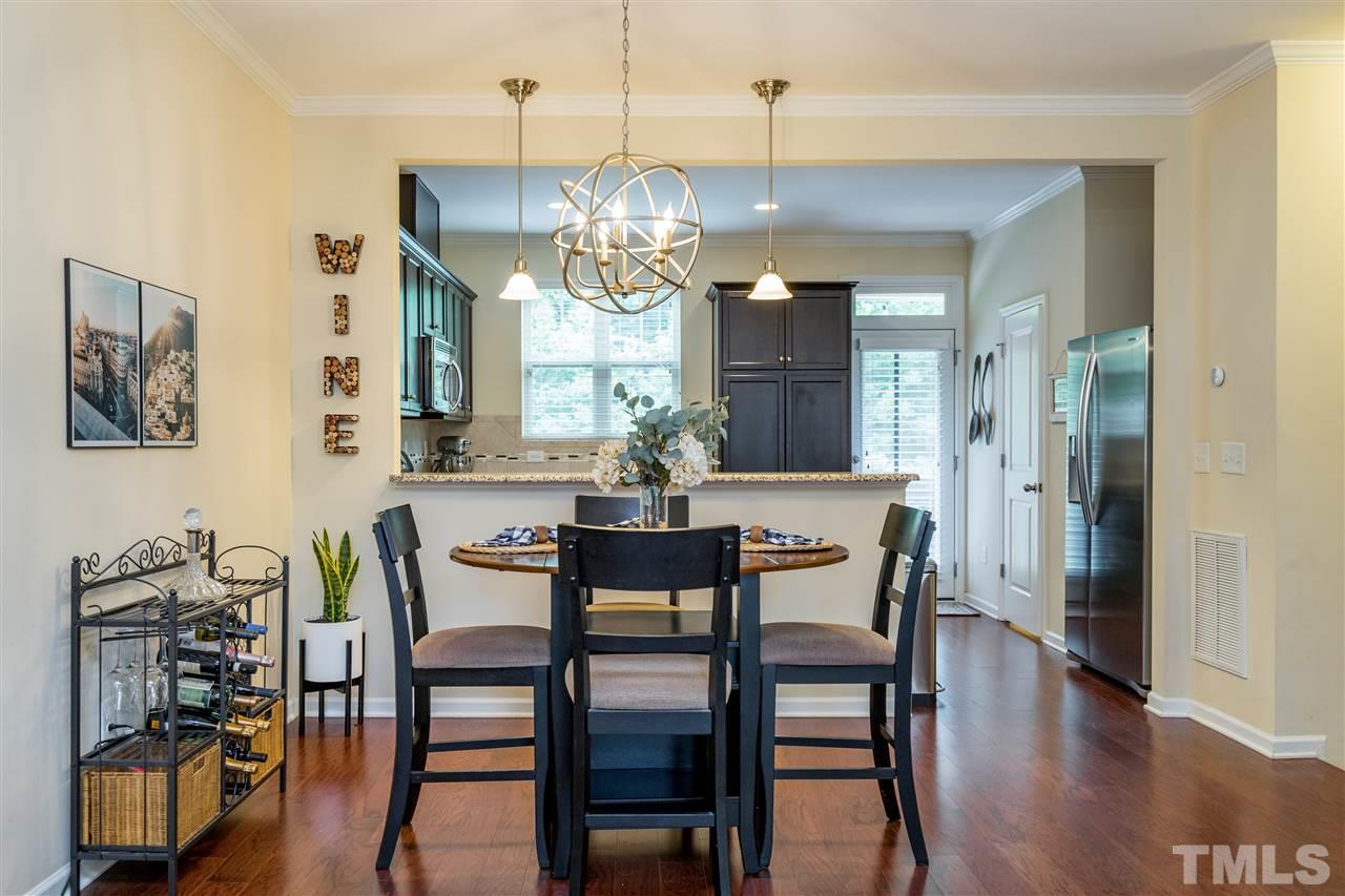 1547 Crafton Way Raleigh, NC 27607 - Photo 10 of 27 a view of a dining room with furniture wooden floor and chandelier