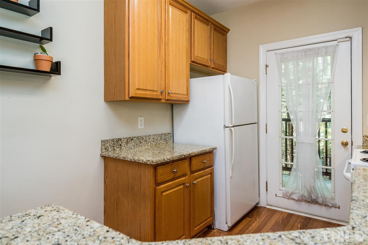 7016 Sandy Forks Road, Unit 201 Raleigh, NC 27615 - Photo 14 of 28 a kitchen with stainless steel appliances granite countertop a refrigerator and a sink