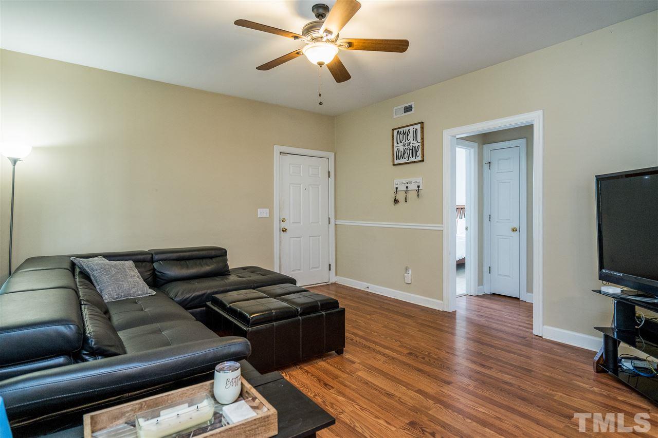 7016 Sandy Forks Road, Unit 201 Raleigh, NC 27615 - Photo 3 of 28 a living room with furniture and a flat screen tv