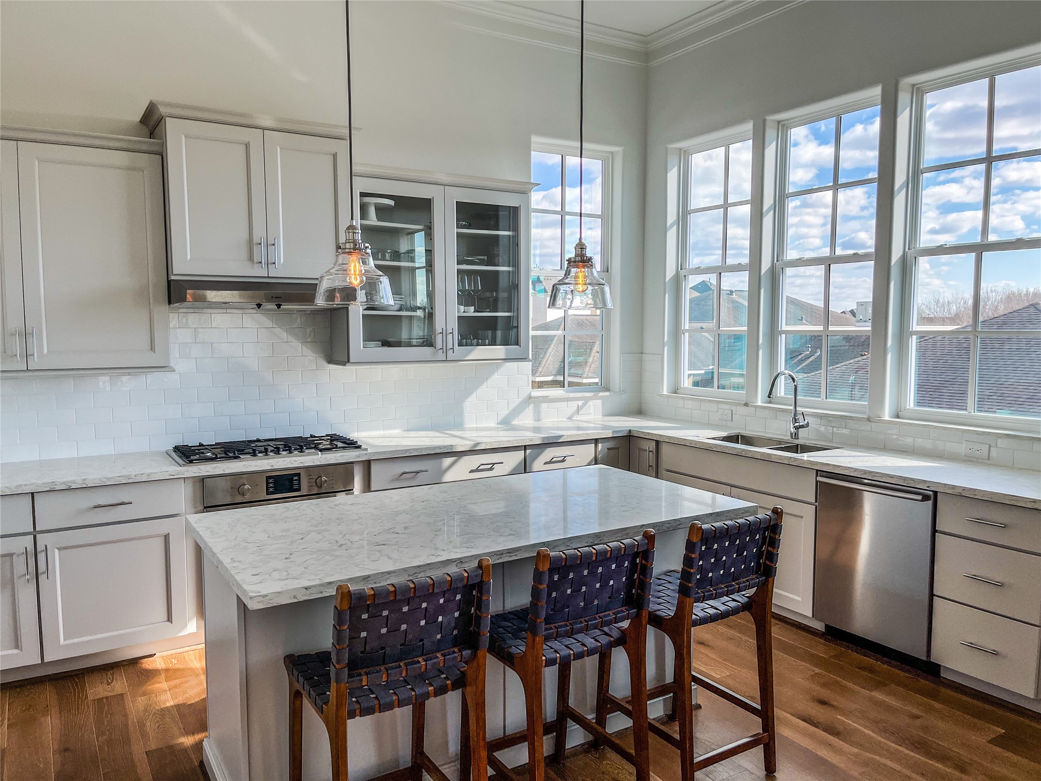 2024 Waterloo Station Road Houston, TX 77045 - Photo 2 of 14 The Kitchen has 42 inch cabinets with undercabinet lighting highlighting the neutral upgraded backsplash. Outlets are hidden underneath the cabinets, leaving the elegant backsplash uninterrupted.