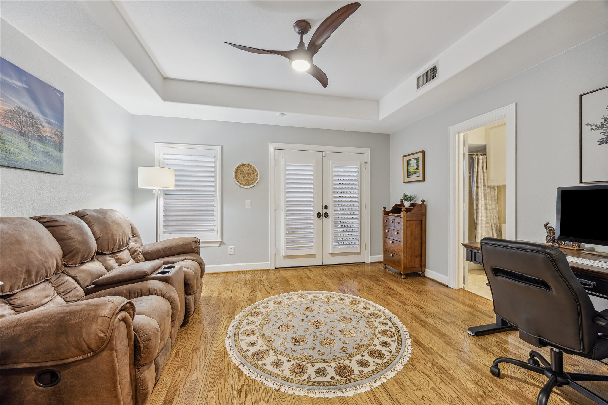544 Bomar Street Houston, TX 77006 - Photo 12 of 43 BEDROOM/STUDY... Another view of this flexible first-floor space highlights classic plantation shutters, a set of French doors leading to a private outdoor patio, and direct access to a well-appointed ensuite bathroom—perfect for guests or a quiet home office retreat.