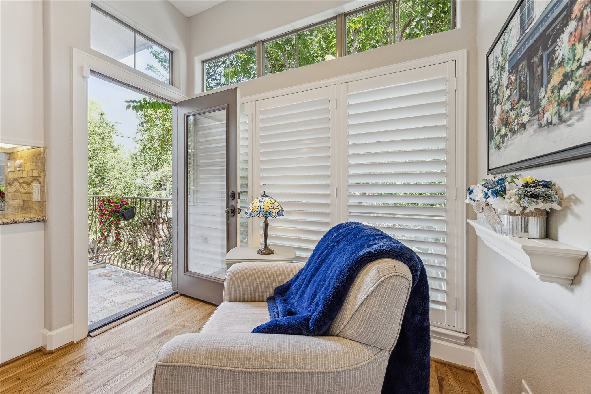 544 Bomar Street Houston, TX 77006 - Photo 25 of 43 BREAKFAST NOOK... This charming space features warm hardwood flooring, plantation shutters, and transom windows that bathe the area in natural light. Conveniently located off the kitchen, it includes easy access to the pantry and opens to an outdoor patio/deck with elegant wrought iron railing and slate flooring—perfect for enjoying morning coffee or casual meals al fresco.