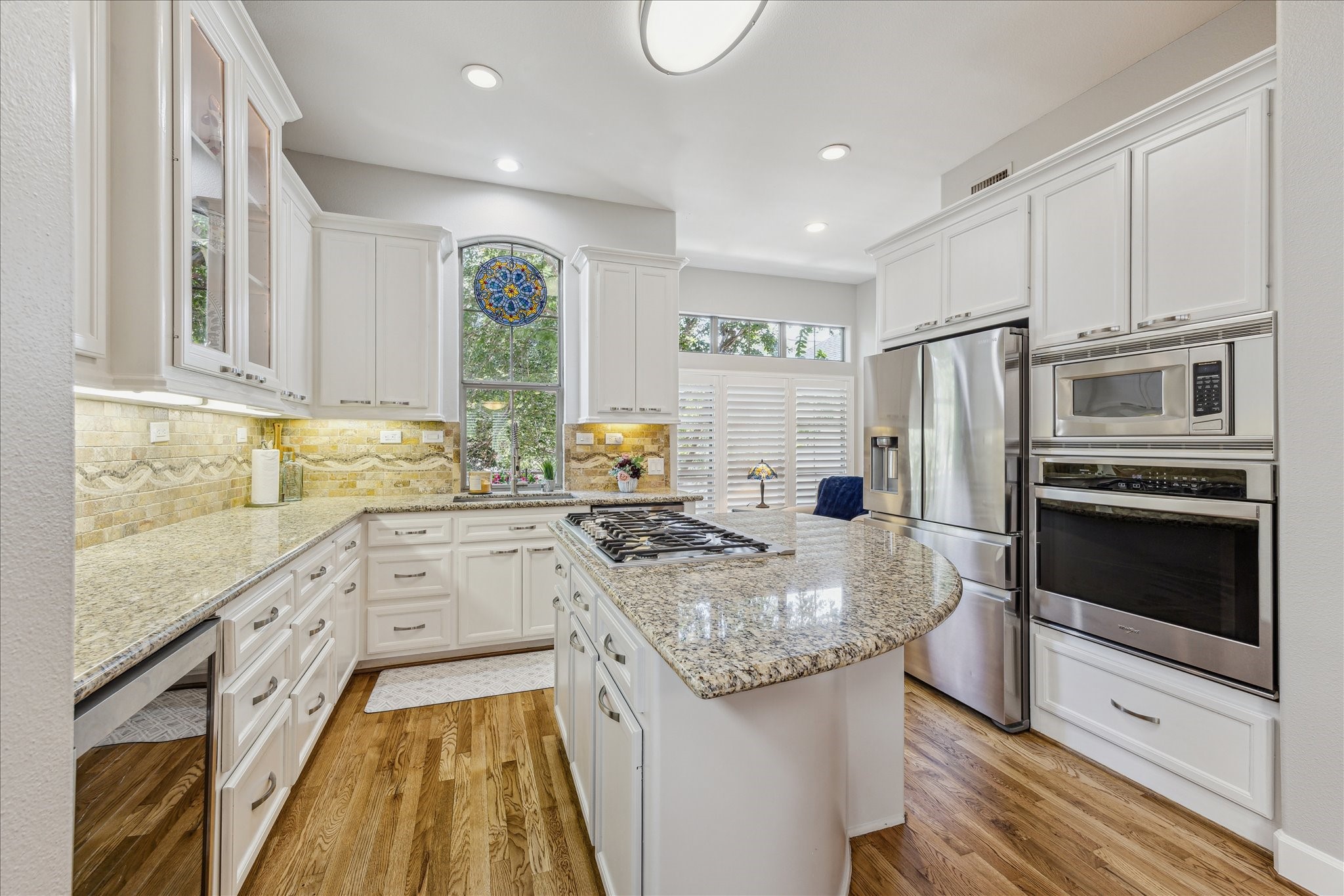 544 Bomar Street Houston, TX 77006 - Photo 25 of 43 Premium stainless steel appliances include a Samsung refrigerator/freezer with water and ice dispenser, a Bosch five-burner gas cooktop with downdraft vent hood, built-in electric oven and microwave, a stainless steel dishwasher, and a climate-controlled wine refrigerator.
