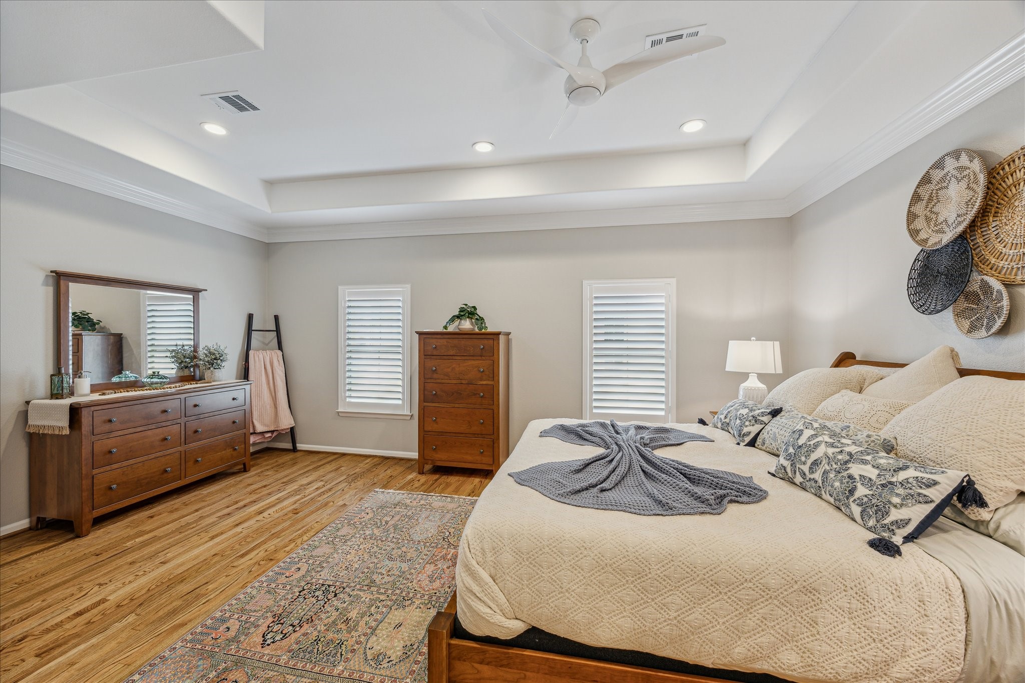 544 Bomar Street Houston, TX 77006 - Photo 29 of 43 PRIVATE PRIMARY RETREAT... Located on the third floor, this serene sanctuary features rich hardwood flooring, elegant crown molding, and a sophisticated coffered ceiling. Plantation shutters, recessed lighting, and a ceiling fan with light kit enhance both comfort and style. High ceilings add to the spacious feel, creating a luxurious and tranquil atmosphere perfect for unwinding.