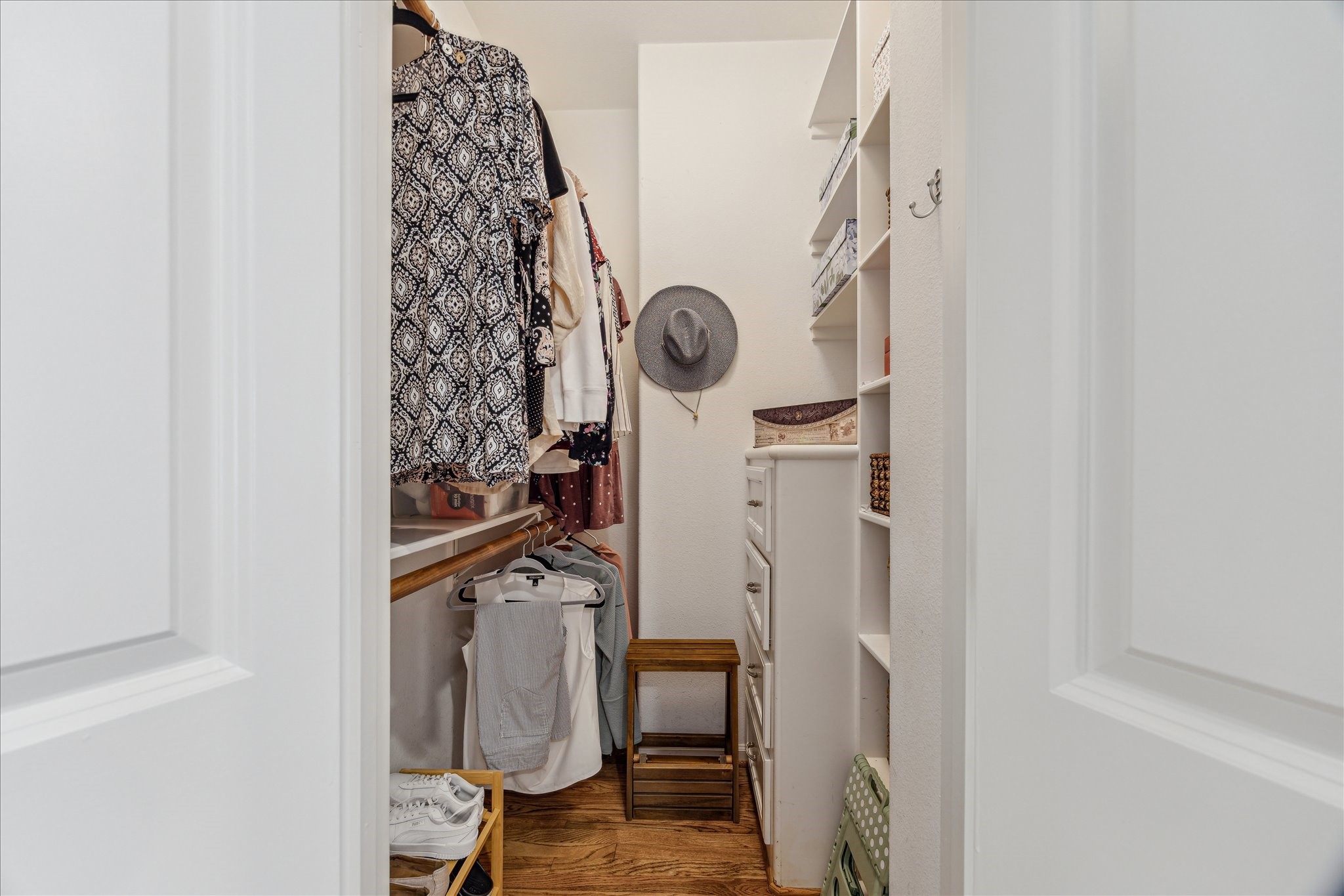 544 Bomar Street Houston, TX 77006 - Photo 32 of 43 PRIMARY CLOSET... One of two spacious closets in the primary suite, this walk-in features rich hardwood flooring, custom built-in cabinetry, and generous storage space for clothing, shoes, and accessories. Thoughtfully designed for both function and style, it offers ample organization and convenience within the suite.