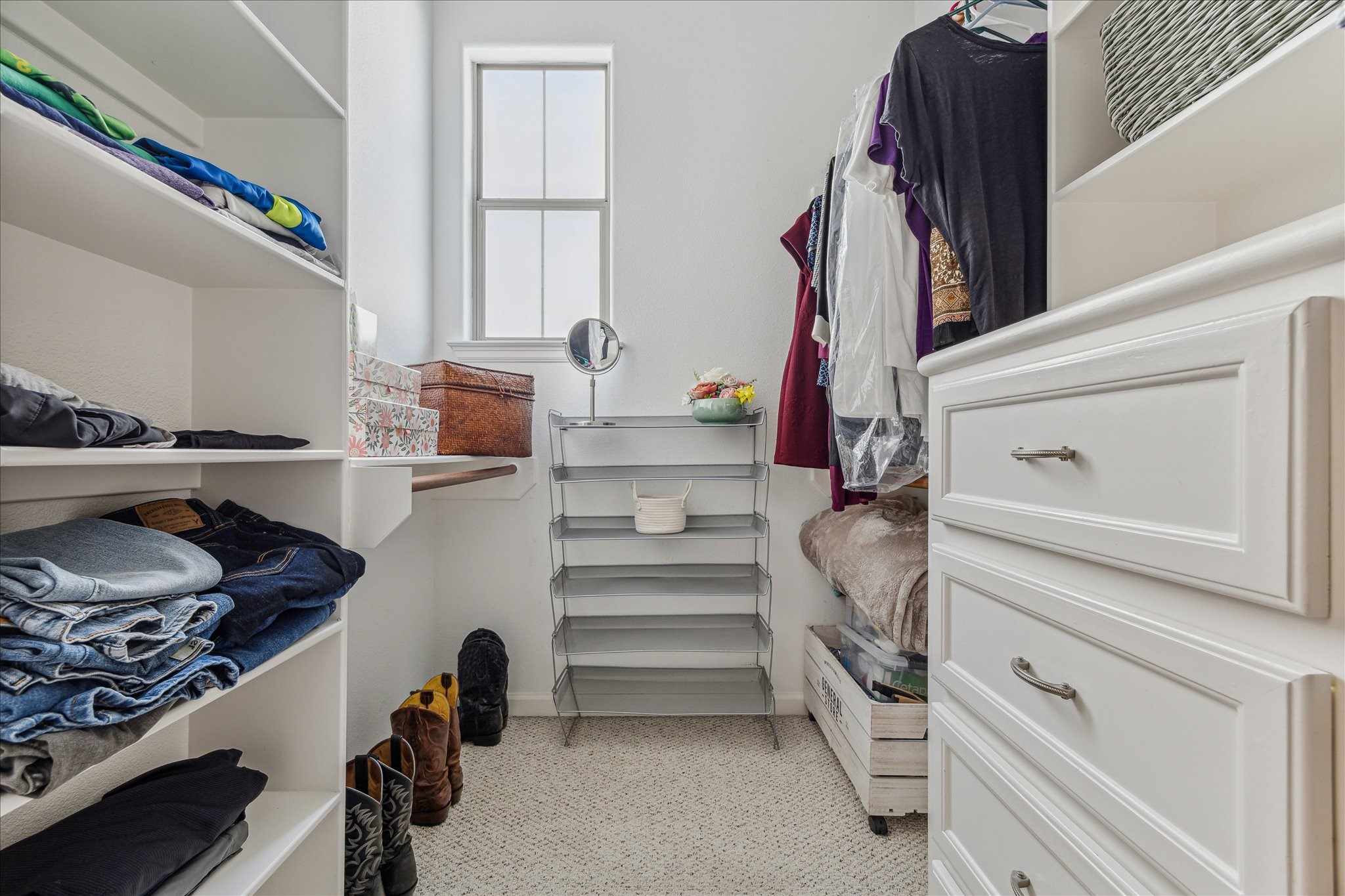 544 Bomar Street Houston, TX 77006 - Photo 35 of 43 PRIMARY CLOSET... This is the second of two spacious closets in the primary suite, conveniently located off the primary bath. It features soft carpeting, custom built-in cabinetry and shelving for optimal organization, recessed lighting, and a privacy-glass window that brings in natural light while maintaining discretion.