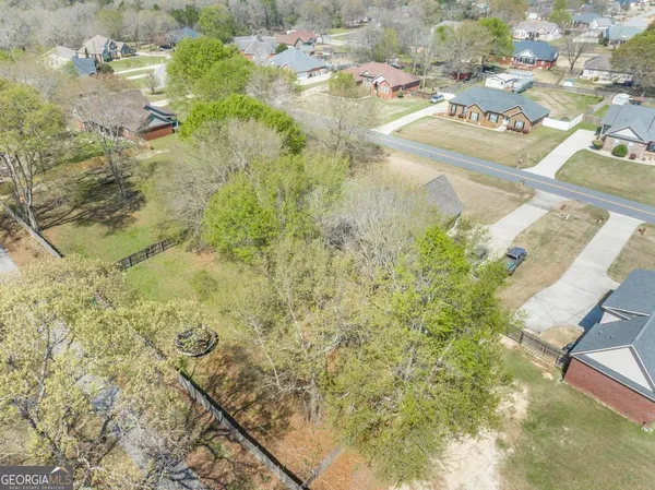 a aerial view of residential houses with green space