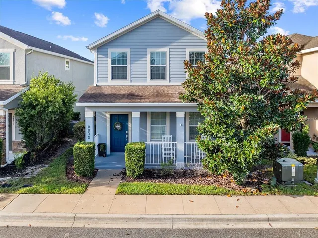 a front view of a house with a garden and plants