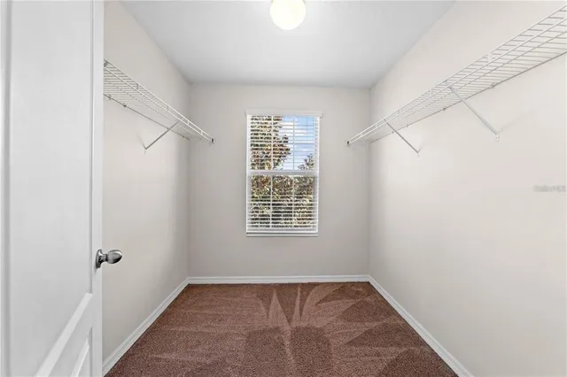 a aerial view of a house with a yard and potted plants