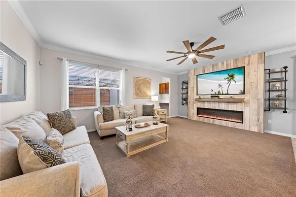 a kitchen with stainless steel appliances granite countertop a sink a stove a refrigerator a microwave oven with white cabinets and wooden floor