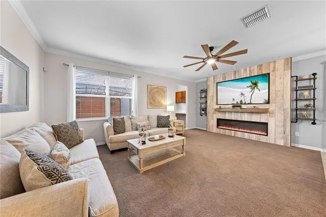 a kitchen with stainless steel appliances granite countertop a sink a stove a refrigerator a microwave oven with white cabinets and wooden floor