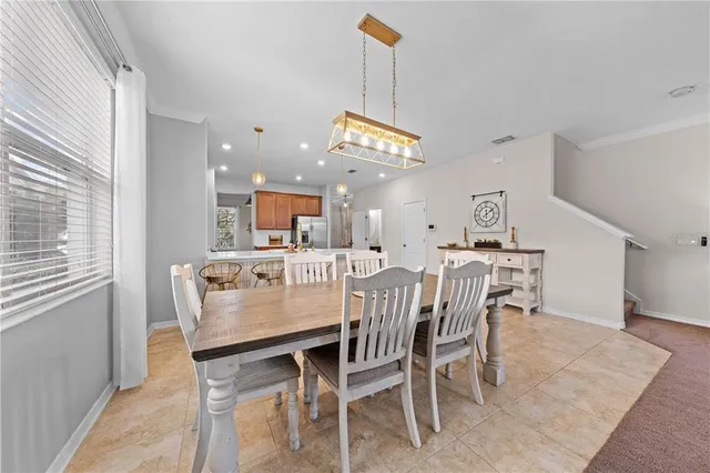 a large kitchen with stainless steel appliances lots of counter top space cabinets and a sink