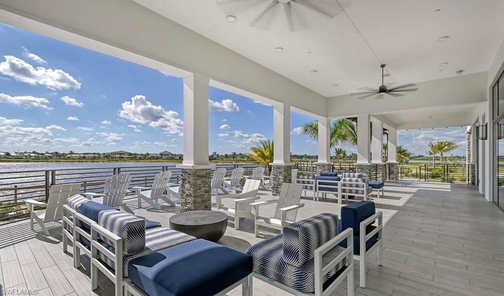 3998 Perseus Street Naples, FL 34120 - Photo 25 of 26 Wooden terrace featuring ceiling fan, an outdoor living space, and a water view