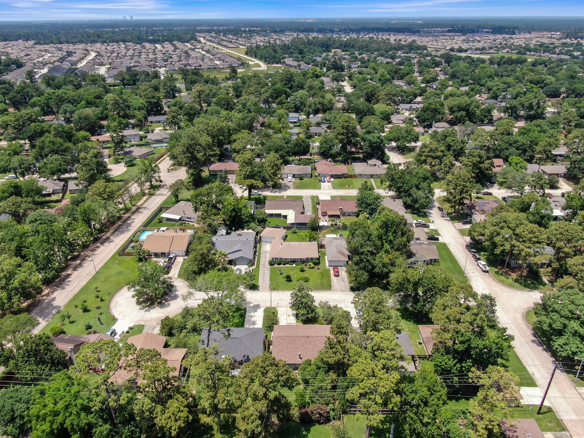 4314 Enchantedgate Drive Spring, TX 77373 - Photo 44 of 47 Aerial photo shows a suburban neighborhood with tree-lined streets and single-family homes. The area appears spacious and green, suggesting a peaceful, residential atmosphere.