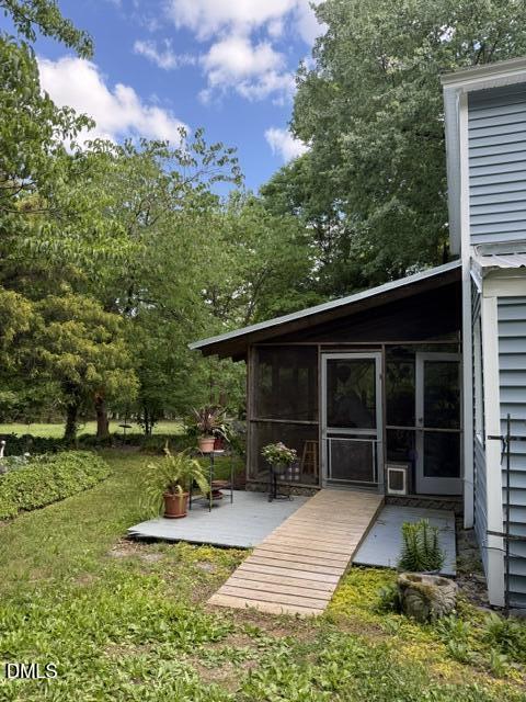 3415 Mt Willing Road Efland, NC 27243 - Photo 25 of 36 a view of a lounge chair and tables in the garden