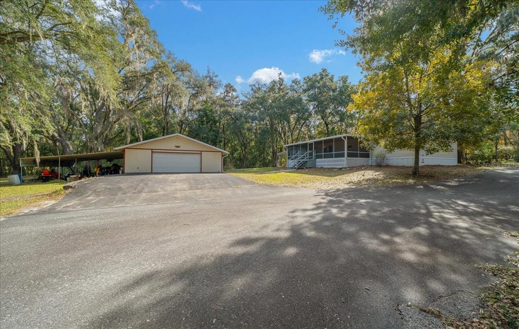 19189 Southwest 29th Street Dunnellon, FL 34432 - Photo 11 of 34 a view of a house with swimming pool and sitting area