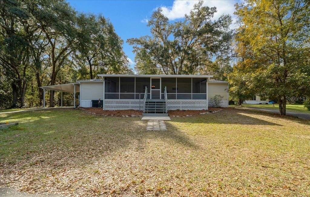 19189 Southwest 29th Street Dunnellon, FL 34432 - Photo 12 of 34 a view of a house with backyard and trees