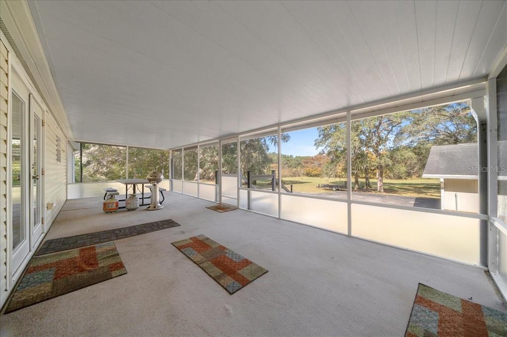 19189 Southwest 29th Street Dunnellon, FL 34432 - Photo 13 of 34 a room with pool table and glass windows