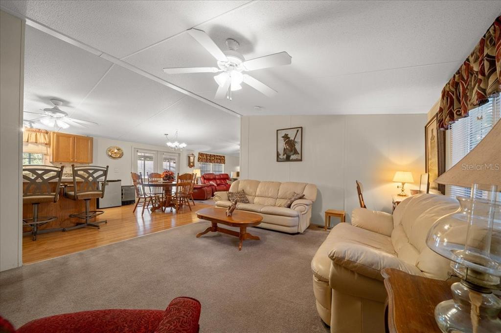 19189 Southwest 29th Street Dunnellon, FL 34432 - Photo 25 of 34 a living room with furniture a chandelier fan and a window