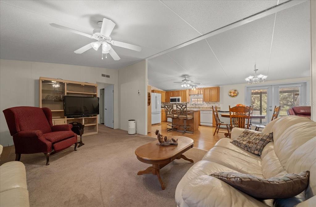 19189 Southwest 29th Street Dunnellon, FL 34432 - Photo 26 of 34 a living room with furniture a flat screen tv and kitchen view