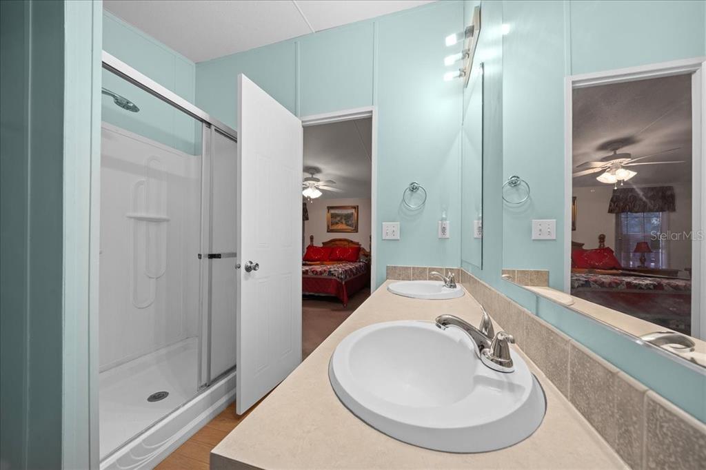 19189 Southwest 29th Street Dunnellon, FL 34432 - Photo 30 of 34 a en suite bathroom with a double vanity sink and a mirror