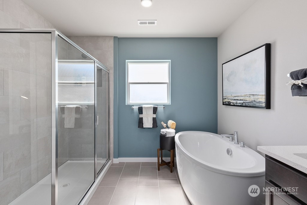 21441 Royal Anne Road Bothell, WA 98021 - Photo 22 of 29 a bathroom with a white bath tub a mirror and a shower