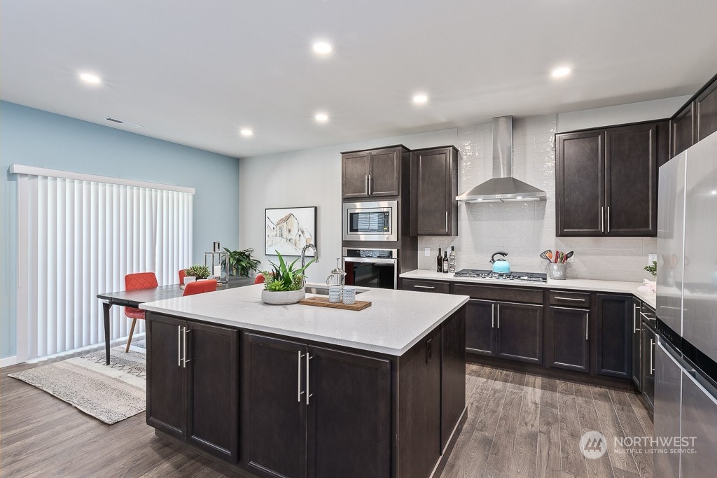 21441 Royal Anne Road Bothell, WA 98021 - Photo 6 of 29 a kitchen with stainless steel appliances kitchen island granite countertop a sink and cabinets