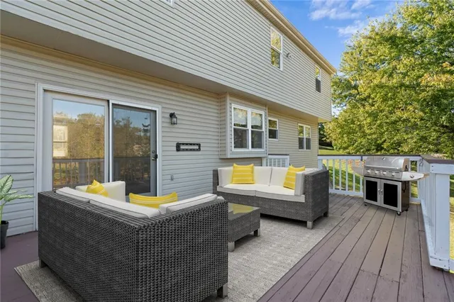 a outdoor space with patio the couches and a dining table and chairs with wooden floor