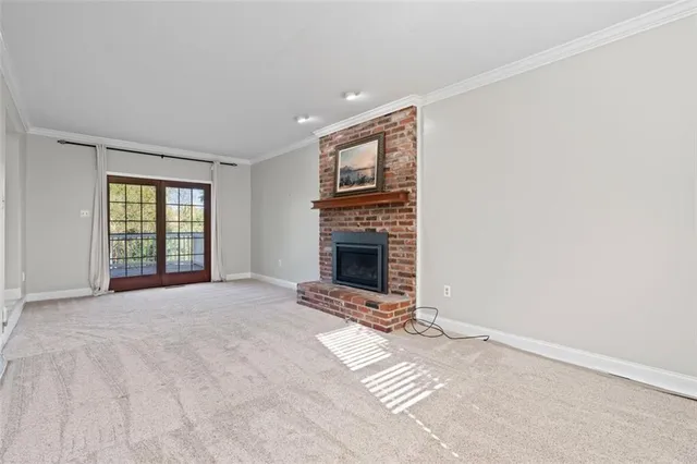 a view of an empty room with a fireplace and a window