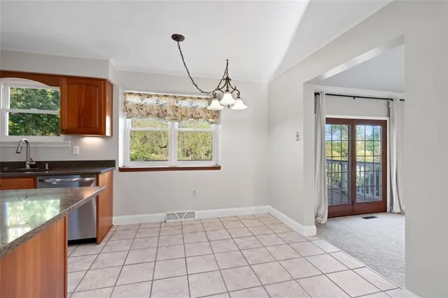 a kitchen with a stove a sink and a window