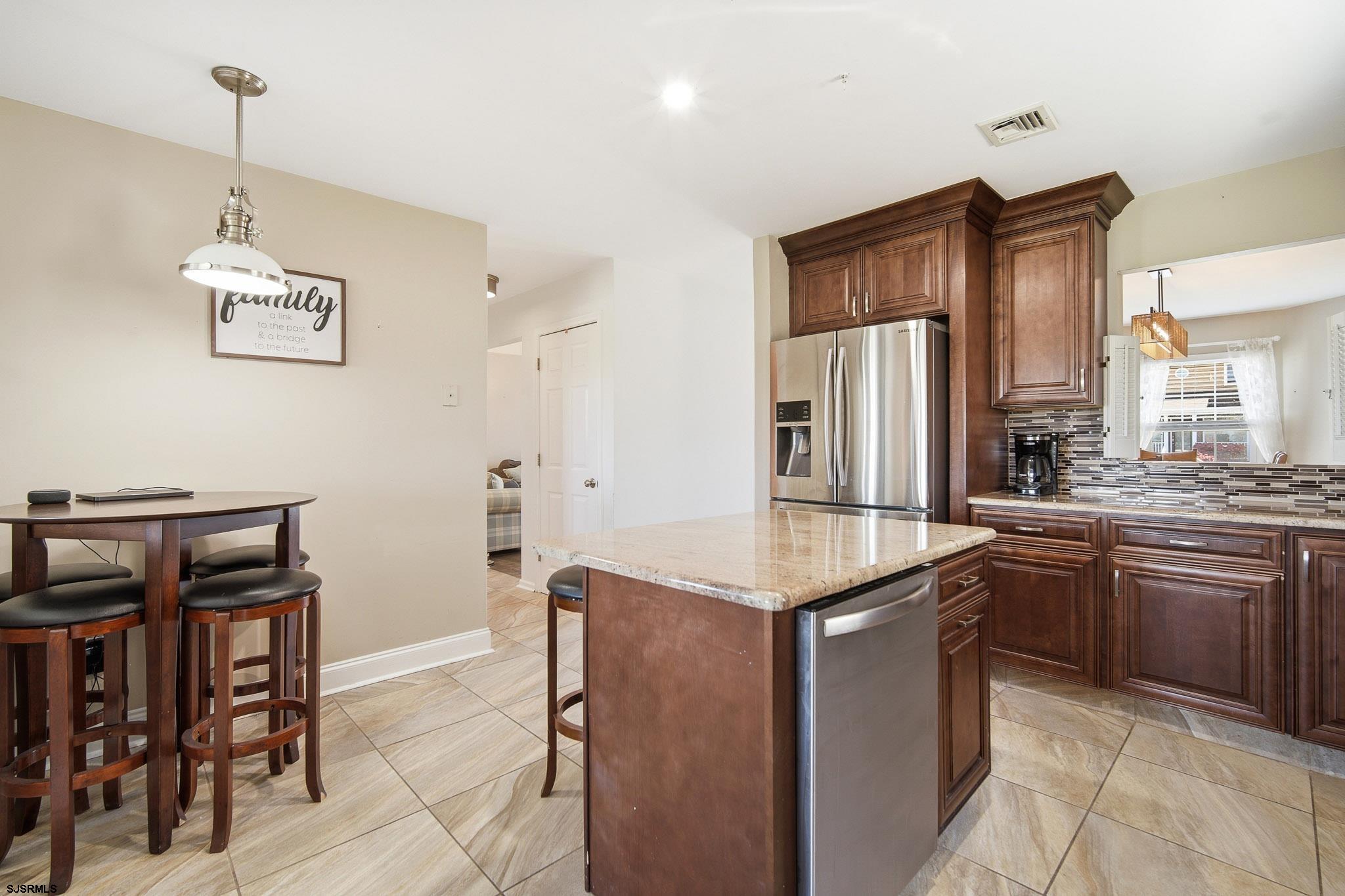 214 Hagen Road Brigantine, NJ 08203 - Photo 15 of 34 a kitchen with stainless steel appliances granite countertop a sink and a refrigerator