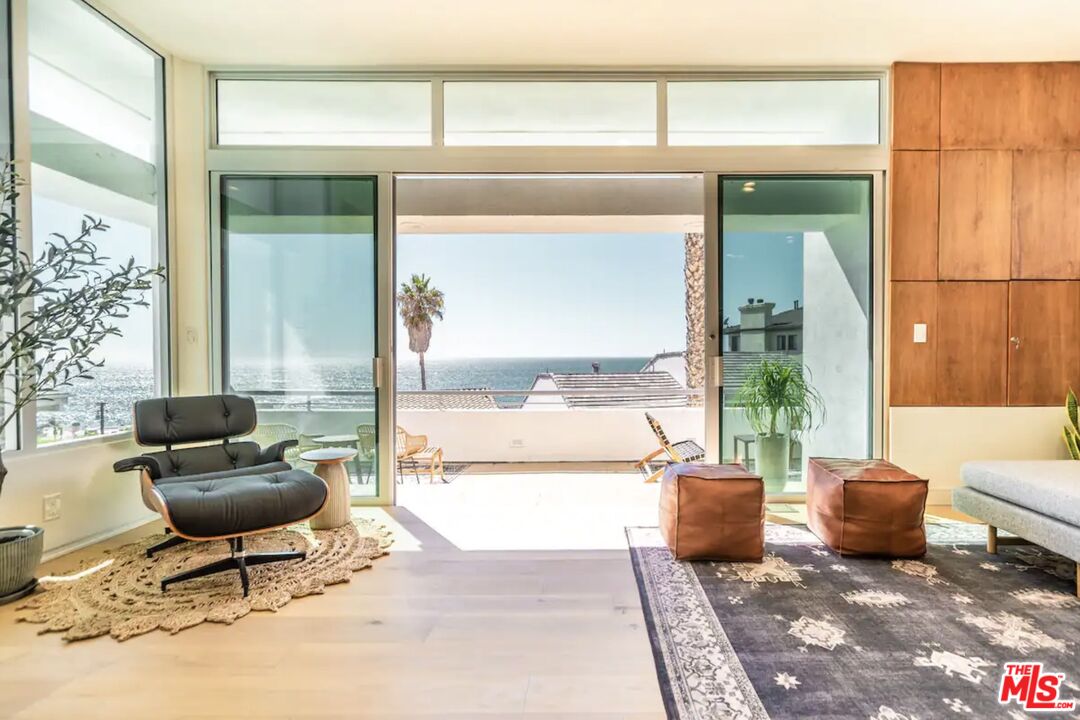 21349 Rambla Vista Malibu, CA 90265 - Photo 11 of 16 a living room with furniture a rug and a potted plant