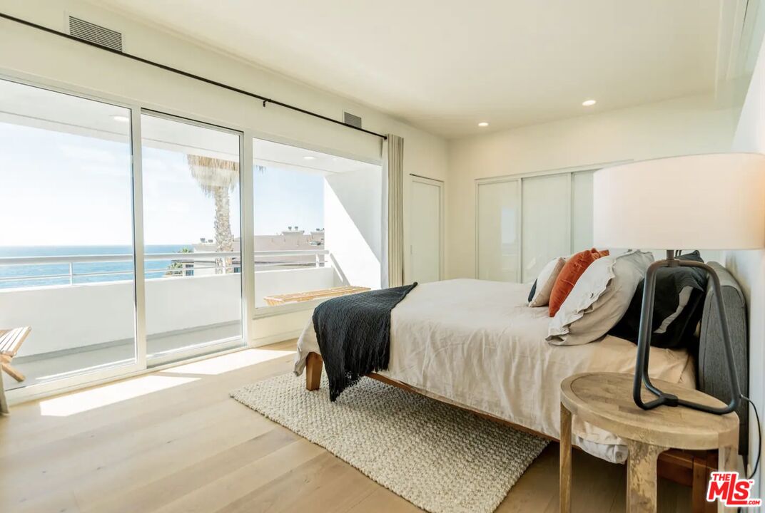 21349 Rambla Vista Malibu, CA 90265 - Photo 3 of 16 a bedroom with a bed and a large window