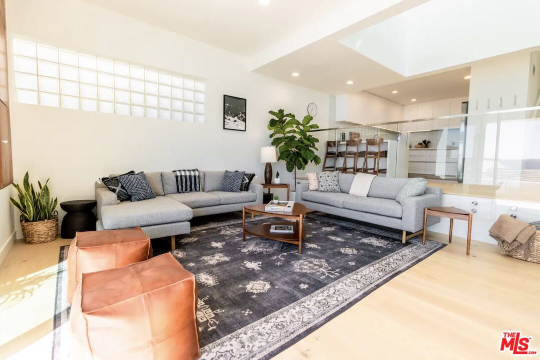 21349 Rambla Vista Malibu, CA 90265 - Photo 4 of 16 a living room with furniture and a rug