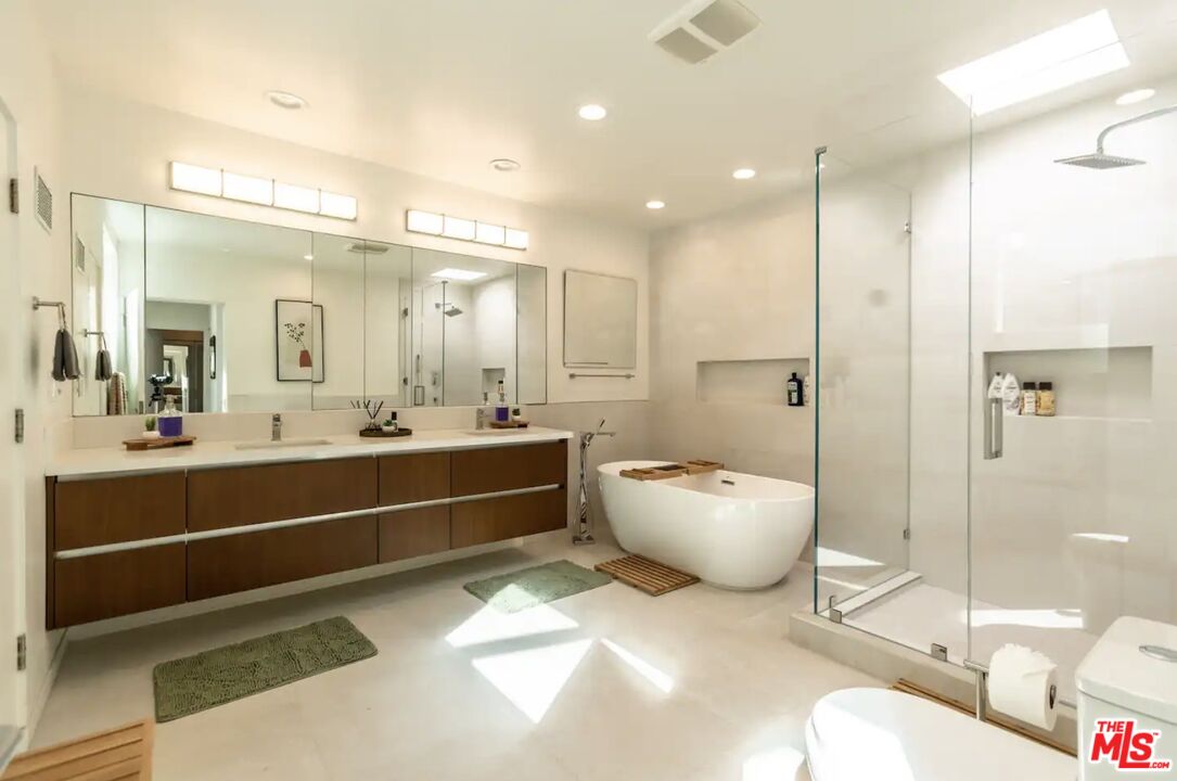 21349 Rambla Vista Malibu, CA 90265 - Photo 9 of 16 a large bathroom with a tub sink shower and mirror
